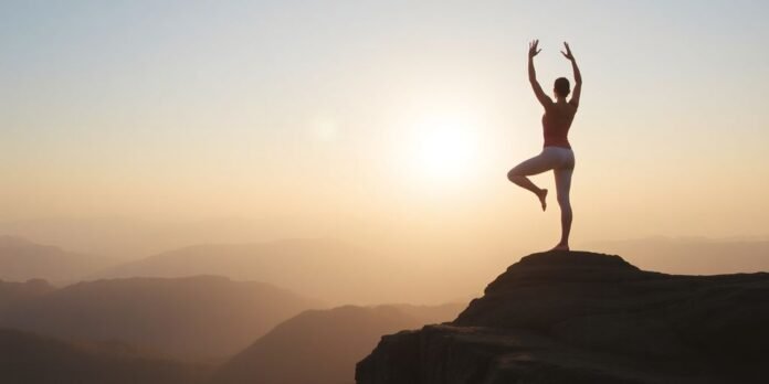 Person practicing yoga at sunrise on rocky ledge.